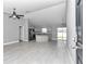 Open-concept kitchen with granite countertops, stainless steel appliances, and gray cabinets at 14978 Sw 24Th Cir, Ocala, FL 34473