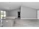Well-lit kitchen with stainless steel appliances, granite countertops, and gray cabinets at 14978 Sw 24Th Cir, Ocala, FL 34473