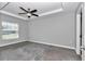 Bright main bedroom features a tray ceiling, ceiling fan, and natural light at 14978 Sw 24Th Cir, Ocala, FL 34473
