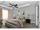 Staged main bedroom features a tray ceiling, ceiling fan, and natural light at 14978 Sw 24Th Cir, Ocala, FL 34473
