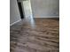 Spacious living room featuring wood-look flooring, neutral walls, and plenty of natural light at 1510 Massa St, Kissimmee, FL 34744