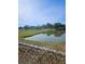 Scenic view of a tranquil pond surrounded by lush greenery and distant houses on a sunny day at 1510 Massa St, Kissimmee, FL 34744