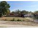 Single-story home with a carport, fenced yard, and compact landscaping under a bright blue sky at 1515 Lady Ave, Ocoee, FL 34761