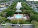 Aerial view of a community pool, playground, and tree lined waterway at 1563 Common Way Rd, Orlando, FL 32814