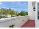 Private balcony view features a community neighborhood view with mature trees and blue skies at 1563 Common Way Rd, Orlando, FL 32814