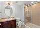 Bathroom with wood vanity, single sink, toilet and walk-in shower with glass enclosure at 1563 Common Way Rd, Orlando, FL 32814