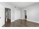 Bedroom with wood floors, closet, neutral paint, and bathroom ensuite at 1563 Common Way Rd, Orlando, FL 32814