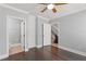 Bedroom featuring hardwood floors and access to a private bath and second-floor staircase at 1563 Common Way Rd, Orlando, FL 32814