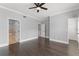 Bright bedroom with hardwood floors, ceiling fan, and ensuite bath at 1563 Common Way Rd, Orlando, FL 32814