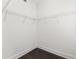White walk-in closet with wire shelving and hardwood floors at 1563 Common Way Rd, Orlando, FL 32814