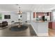 Bright dining area features updated flooring, neutral walls, chandelier, and an archway leading to the kitchen at 1563 Common Way Rd, Orlando, FL 32814