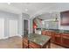 Updated kitchen features granite counters and stainless steel appliances, next to the staircase and small washroom at 1563 Common Way Rd, Orlando, FL 32814