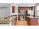 Stylish kitchen with stainless steel appliances, granite counters, and dark wood cabinets at 1563 Common Way Rd, Orlando, FL 32814