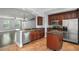 Updated kitchen boasts stainless steel appliances, granite counters, tile floors, and stylish wood cabinetry at 1563 Common Way Rd, Orlando, FL 32814