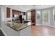 Updated kitchen boasts stainless steel appliances, granite counters, tile floors, and a door leading to the balcony at 1563 Common Way Rd, Orlando, FL 32814