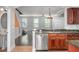 Updated kitchen with granite countertops, stainless steel appliances, and view of the staircase at 1563 Common Way Rd, Orlando, FL 32814