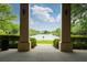 Framed view of a lake through the open pillars of a pavilion at 1563 Common Way Rd, Orlando, FL 32814
