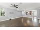 Bright and airy living room featuring dark wood floors, ceiling fan, and large windows at 1563 Common Way Rd, Orlando, FL 32814