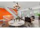 Bright living room with a view of the staircase, featuring a chandelier, and comfortable seating at 1563 Common Way Rd, Orlando, FL 32814