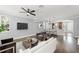 Spacious living room features updated flooring, neutral walls, ceiling fan, and an archway leading to the kitchen at 1563 Common Way Rd, Orlando, FL 32814