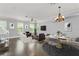 Spacious open floor plan with updated flooring, neutral walls, and an adjacent staircase at 1563 Common Way Rd, Orlando, FL 32814