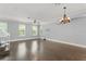 Bright and airy living room featuring hardwood floors, natural light, and a modern ceiling fan at 1563 Common Way Rd, Orlando, FL 32814