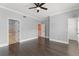 Spacious main bedroom with wood floors, crown molding, ceiling fan, and ensuite bathroom at 1563 Common Way Rd, Orlando, FL 32814