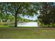 Beautiful pond with mature trees on the shoreline at 1563 Common Way Rd, Orlando, FL 32814