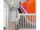 An interior staircase features wood stairs, white trim, and an accent colored wall at 1563 Common Way Rd, Orlando, FL 32814