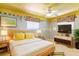 Staged bedroom with a bed, side tables, TV, and neutral tones with colorful accents at 160 Archers Pt., Longwood, FL 32779