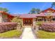 Charming home exterior featuring a stone accents, well-manicured landscaping and a inviting walkway at 160 Archers Pt., Longwood, FL 32779