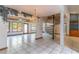 Bright open living area with a spiral staircase and chandelier under interesting ceiling design at 160 Archers Pt., Longwood, FL 32779