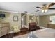 Well-lit bedroom featuring hardwood floors, ceiling fan, and access to the updated bathroom at 1621 Chippewa Trl, Maitland, FL 32751