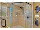 Close up of the tiled shower with a glass door and bronze finish shower head at 1621 Chippewa Trl, Maitland, FL 32751