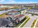 Scenic residential community featuring a tranquil pond and new construction in the backdrop on a sunny day at 1799 Tropical Palms Cir, Kissimmee, FL 34747