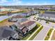 Scenic residential community featuring a tranquil pond and new construction in the backdrop on a sunny day at 1799 Tropical Palms Cir, Kissimmee, FL 34747