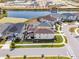 Aerial view of a home with a well maintained yard, and a calm serene street at 1799 Tropical Palms Cir, Kissimmee, FL 34747