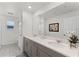 Bright bathroom featuring a large mirror, double vanity and a tiled floor at 1799 Tropical Palms Cir, Kissimmee, FL 34747