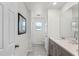 Bright bathroom featuring a large mirror, single vanity and a tiled floor at 1799 Tropical Palms Cir, Kissimmee, FL 34747