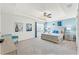 Spacious bedroom with tray ceiling, ceiling fan, light blue accent wall, and charming decor at 1799 Tropical Palms Cir, Kissimmee, FL 34747