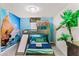 This bedroom boasts a custom bunk bed with a slide and a Moana-themed mural for an adventurous vibe at 1799 Tropical Palms Cir, Kissimmee, FL 34747