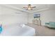 Bright bedroom featuring a ceiling fan, closet, TV, dresser and chair at 1799 Tropical Palms Cir, Kissimmee, FL 34747