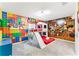 Colorful bedroom features a custom bunk bed with slide and a vibrant Toy Story-themed mural, perfect for  at 1799 Tropical Palms Cir, Kissimmee, FL 34747