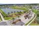 Aerial view of a gated community entrance featuring lush landscaping and palm trees surrounding the signage at 1799 Tropical Palms Cir, Kissimmee, FL 34747