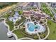 Expansive community pool area with water slides, pools, cabanas, and playground surrounded by palm trees at 1799 Tropical Palms Cir, Kissimmee, FL 34747