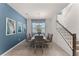 Modern dining area with a stylish table, six chairs, a blue accent wall, and contemporary artwork at 1799 Tropical Palms Cir, Kissimmee, FL 34747