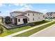 Rear exterior of the home with screened patio and lush backyard at 1799 Tropical Palms Cir, Kissimmee, FL 34747