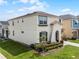 Beautiful two-story home featuring a well-manicured lawn, landscaped yard, and attached garage at 1799 Tropical Palms Cir, Kissimmee, FL 34747