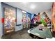 The game room features comic character wall art, an air hockey table, and a foosball table at 1799 Tropical Palms Cir, Kissimmee, FL 34747
