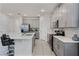The kitchen features an island with barstool seating and stainless steel appliances at 1799 Tropical Palms Cir, Kissimmee, FL 34747